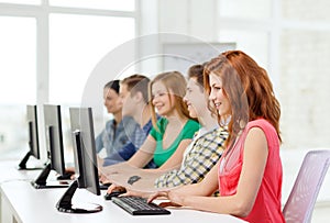 Female student with classmates in computer class