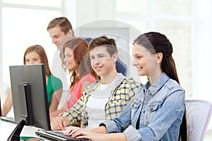 Female student with classmates in computer class