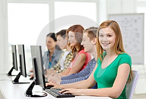 Female student with classmates in computer class