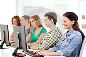 Female student with classmates in computer class