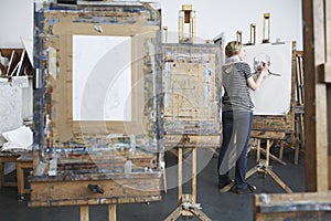 Female Student Drawing With Charcoal In Art Studio