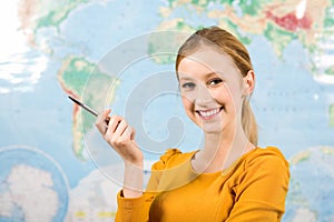 Female student in front of world map