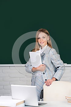 Female student holding book in university, school education, Young woman study in college classroom.