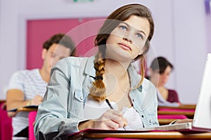 Female student with laptop in classroom