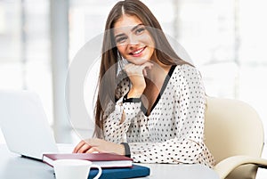 Female student with laptop in a high school library