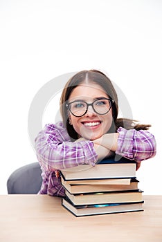 Female student leaning on the with books