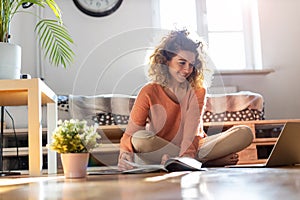 Female student learning in home setting with laptop