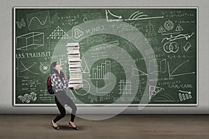 Female student lifting many books