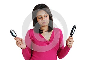 Female student looking at magnifying glass
