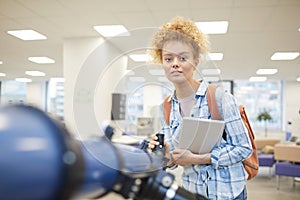 Female Student Posing with Telescope