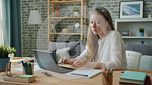 Female student pretty young woman studying at home using laptop typing writing