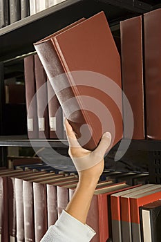 Female student reaching for a book