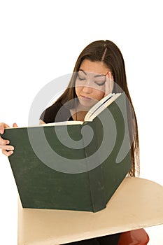 Female student reading a big book falling asleep