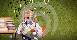 Female student reading book while letters flying in background