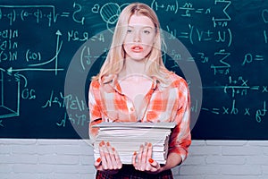 Female student ready to write exam testing. Blonde woman in front of chalkboard. Ready for study. Before exam