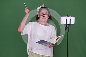 Female student running her presentation from home, in front of her smartphone