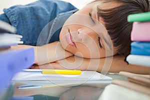 Female student sleeping among her books