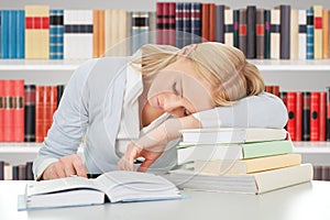 Female student sleeping in a library