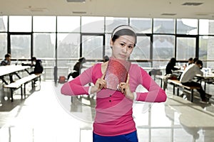 A female student standing with a book