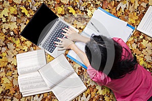 Female Student Studying on The Autumn Leaves