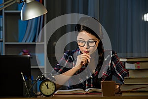 Female student studying for next day exam