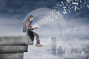 Female student studying on rooftop