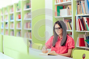 Female Student Studying and Taking Notes in the Library