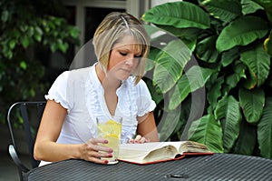 Female Student Studying with Textbook