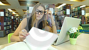 Female student taking notes from book