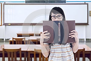 Female student with textbook in class