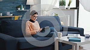 Female student using digital tablet to do remote school work