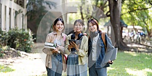 female student is walking to class with friends and stop to look at the camera. back to school concept