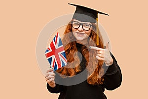 Female student wearing glasses with UK flag. Graduation day.