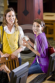 Female students hanging out by library computers