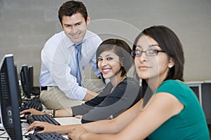 Female Students With Professor In Computer Lab