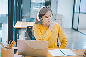 Female students studying online feel aches and pains while sitting online for long periods of time