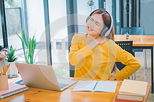 Female students studying online feel aches and pains while sitting online for long periods of time