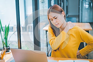 Female students studying online feel aches and pains while sitting online for long periods of time