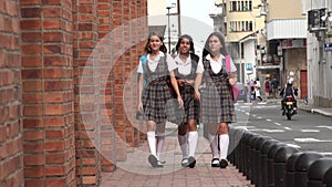 Female Students Walking On Sidewalk