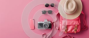 Female summer vacation set on color background. Flatlay. Hat, sunglasses, backpack, phone and camera on pink