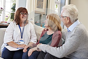 Female Support Worker Visits Senior Couple At Home