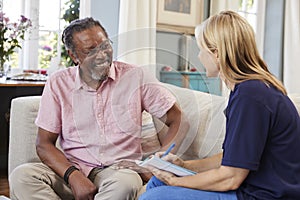 Female Support Worker Visits Senior Man At Home