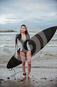 Female surfer in spring wetsuit