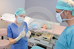 Female surgeon anaesthetist at patient operating room photo