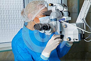 Female surgeon doctor performing laser eye vision correction ope