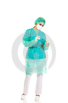 Female surgeon doctor with a scalpel performs the surgery