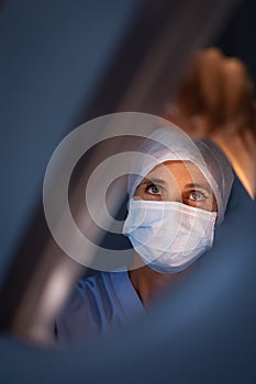 Female surgeon fixing surgical light at hospital