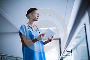 Female surgeon holding digital tablet