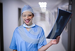 Female surgeon holding x-ray at hospital