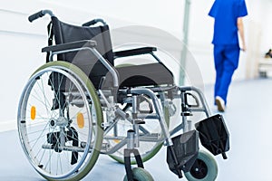 female surgeon in hospital corridor, wheelchair